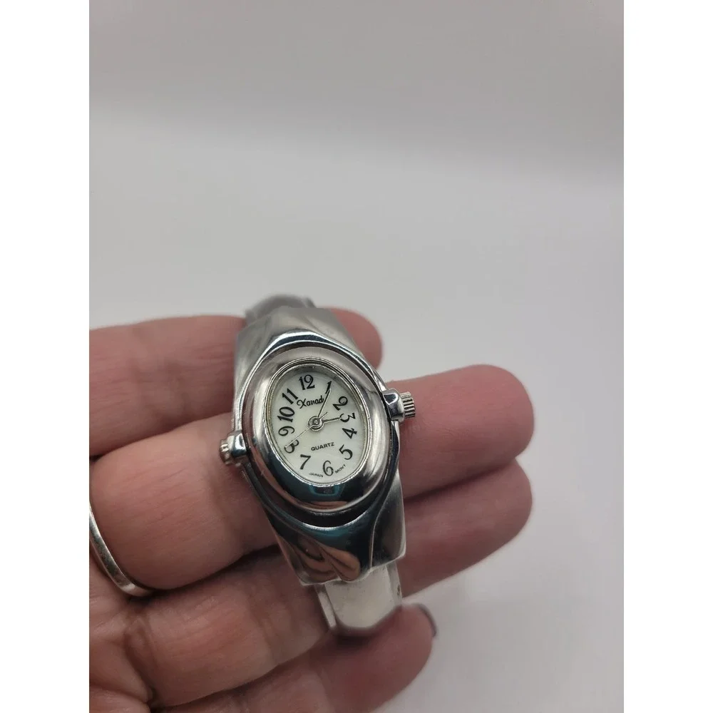 Xanadu Women's Silver Tone Hinged Cuff Bangle Quartz Watch Oval Dial Reverse